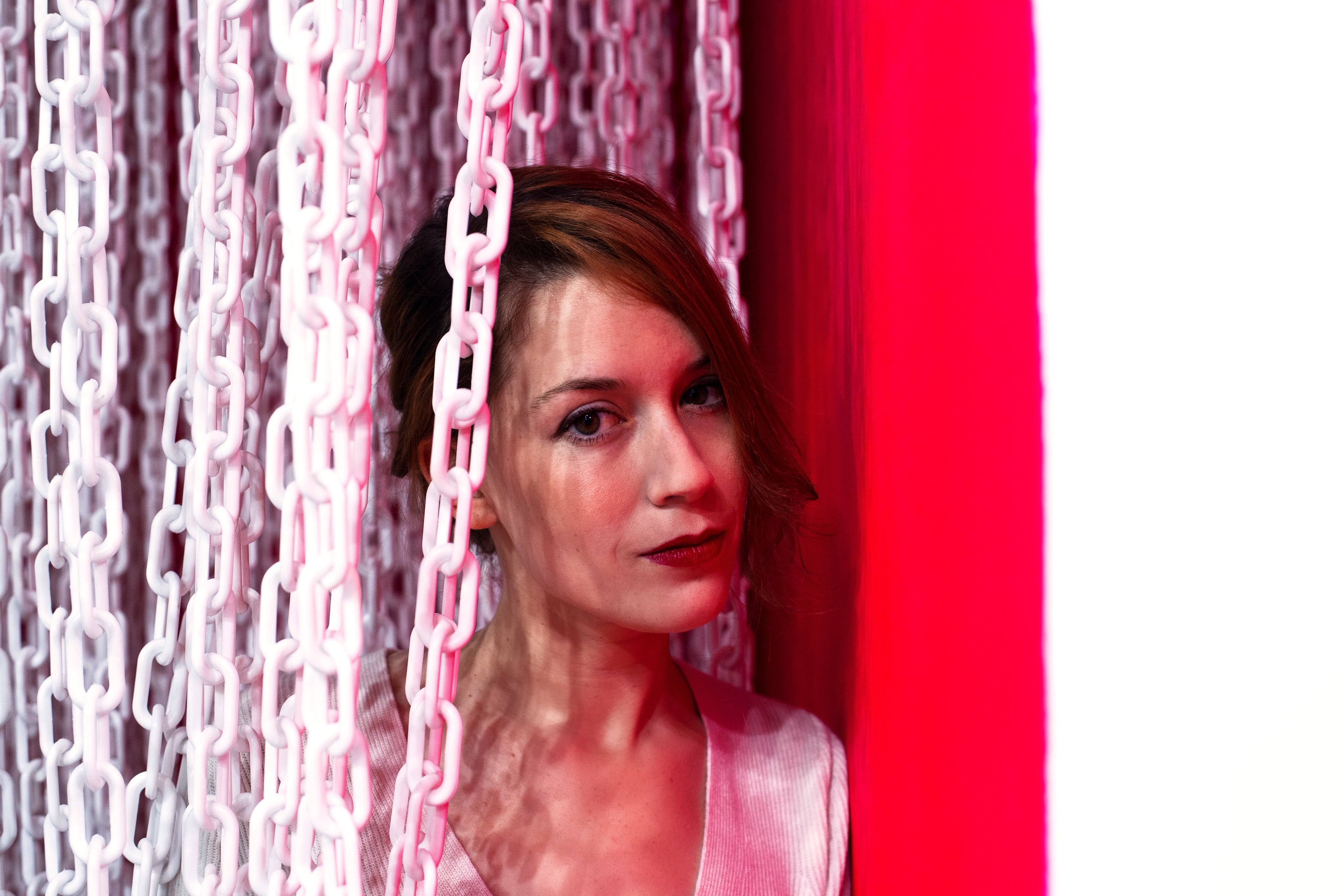 files/woman-brushing-aside-a-curtain-of-white-chains.jpg